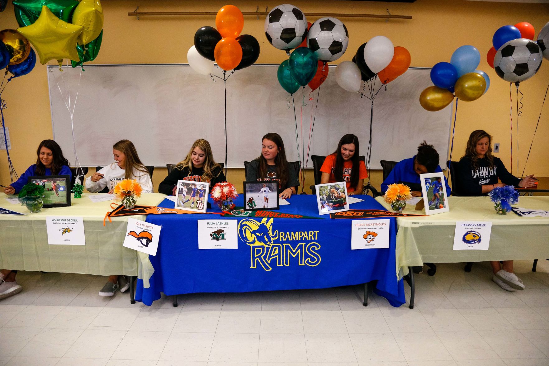 SIGNING DAY: Rampart athletes sign their National Letter of Intent